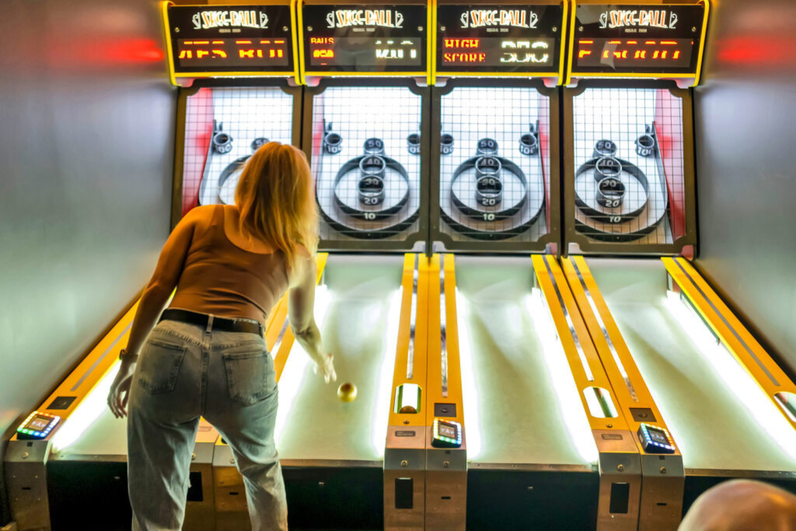 Woman playing Skee-Ball at Sports & Social in Allentown, PA.
