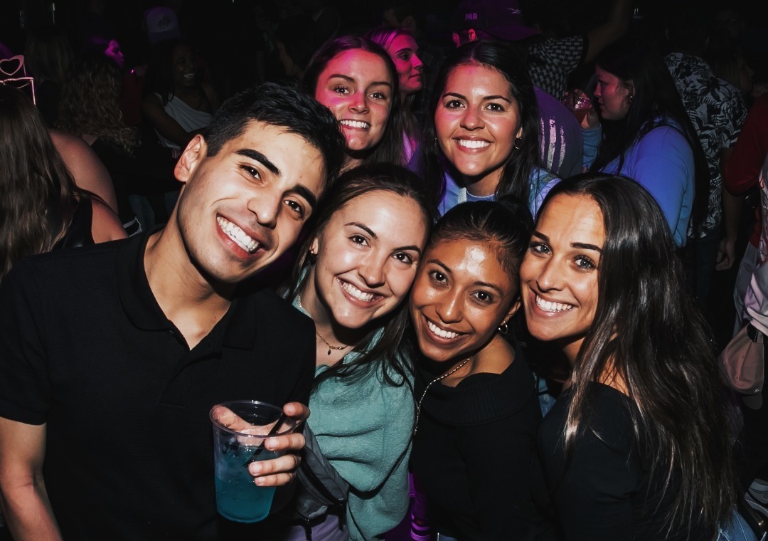 Close up group photo of friends enjoying nightlife at Sports & Social in Allentown, PA.