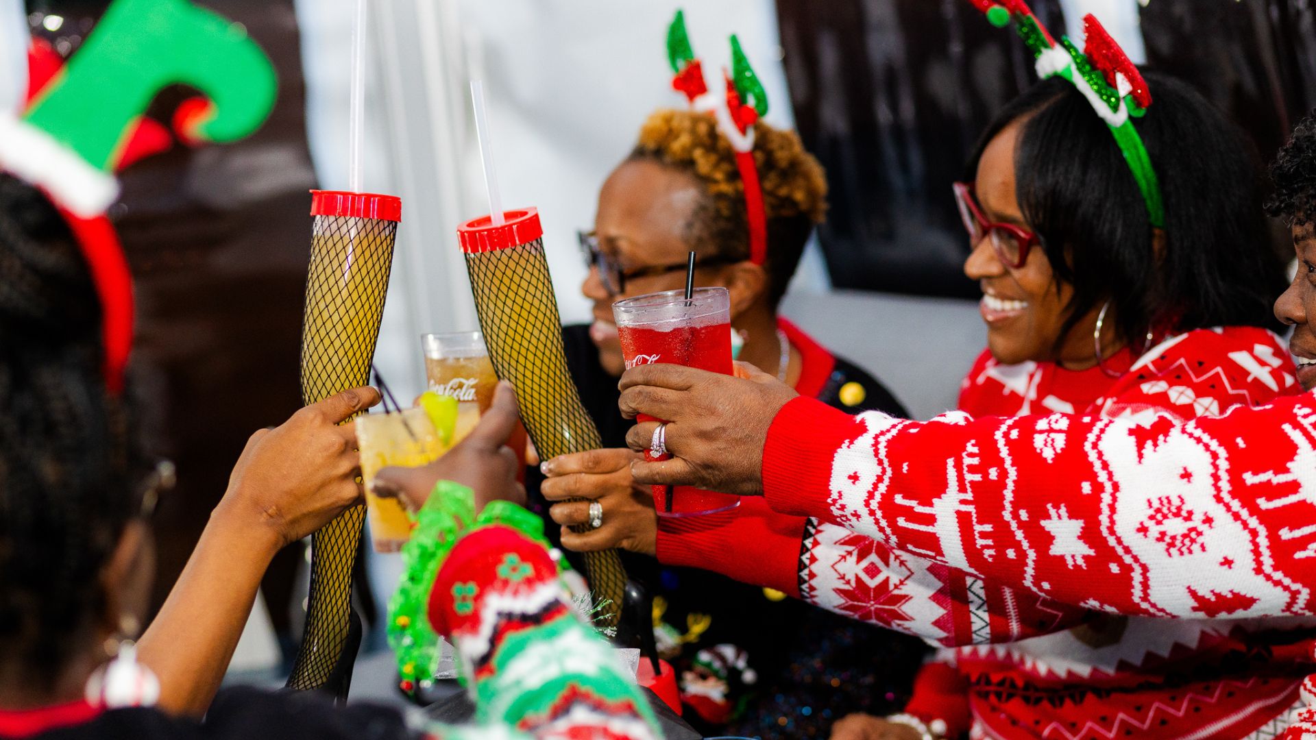 Ladies in Christmas Sweaters drinking holiday cocktails