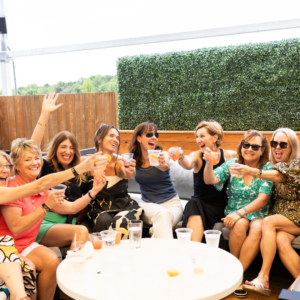 Group of friends enjoying cocktails on AVA Rooftop