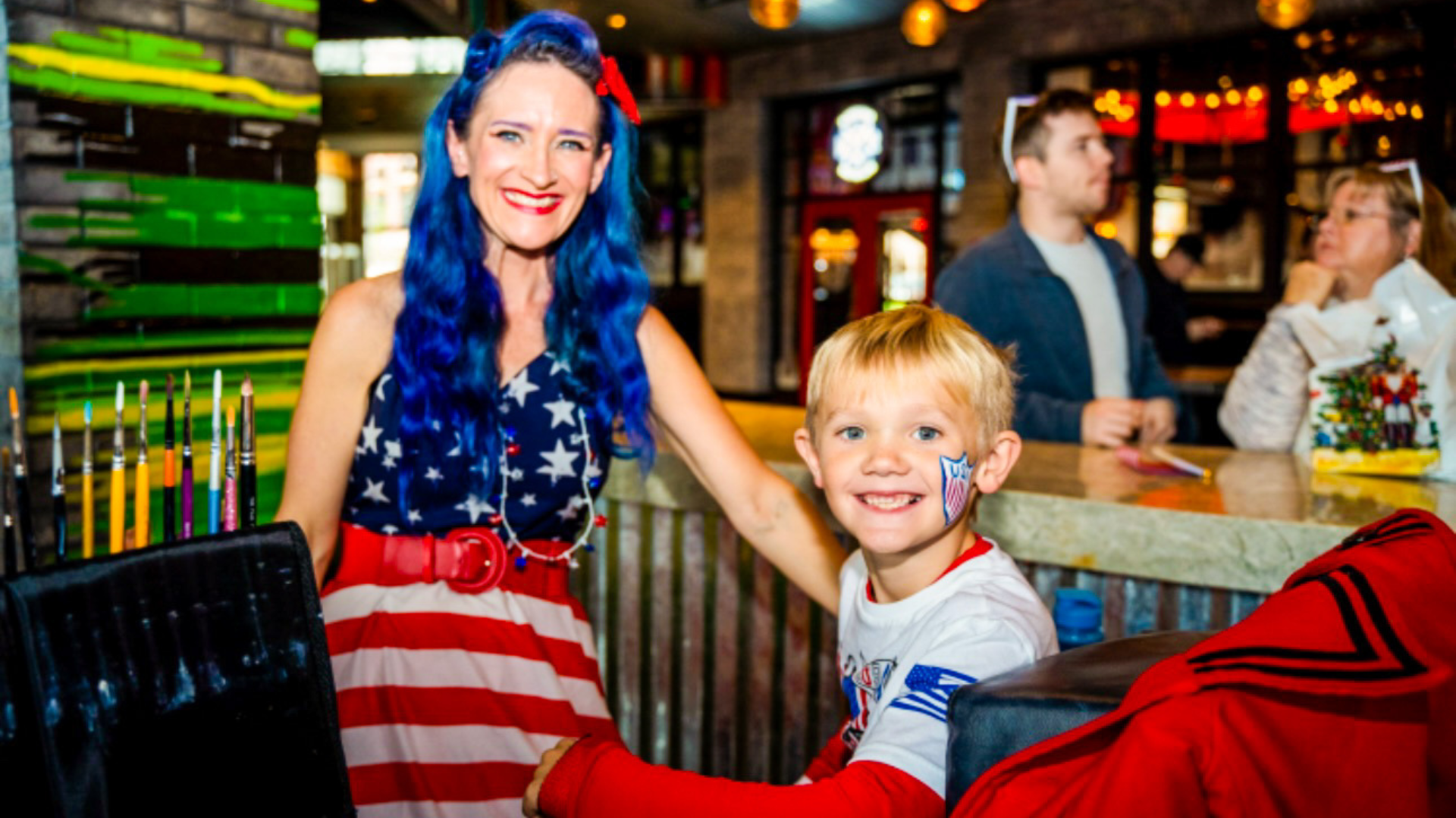 Woman and child celebrating memorial day weekend with USA themed clothing and accessories.