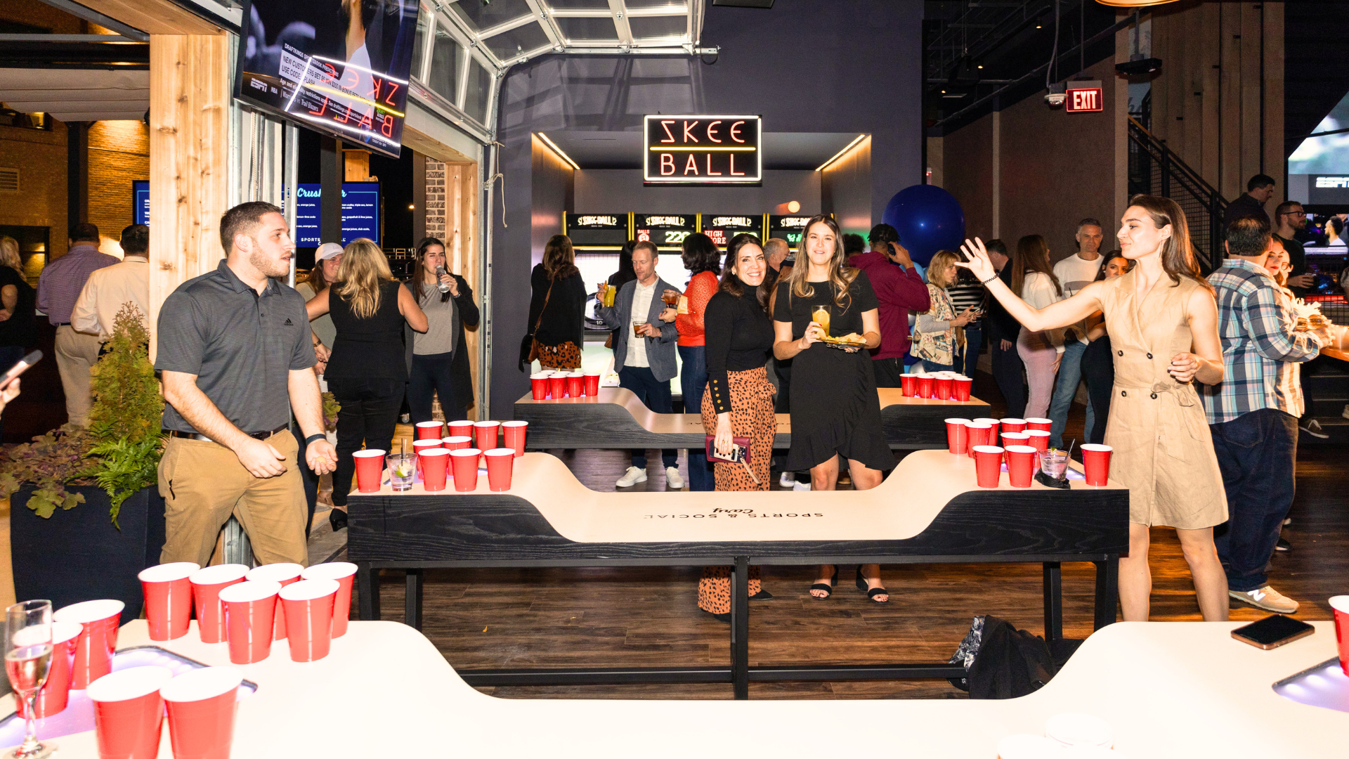 People playing cup or beer pong at a beer pong tournament