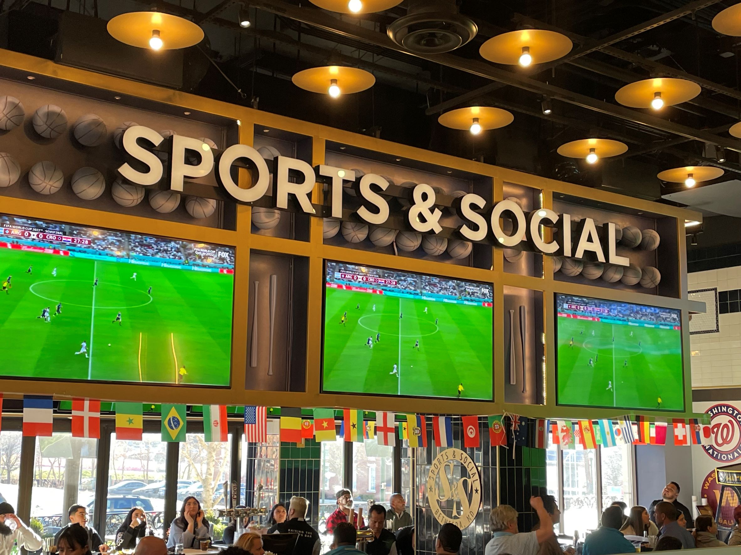 group enjoying family friendly soccer watch party at Sports & Social