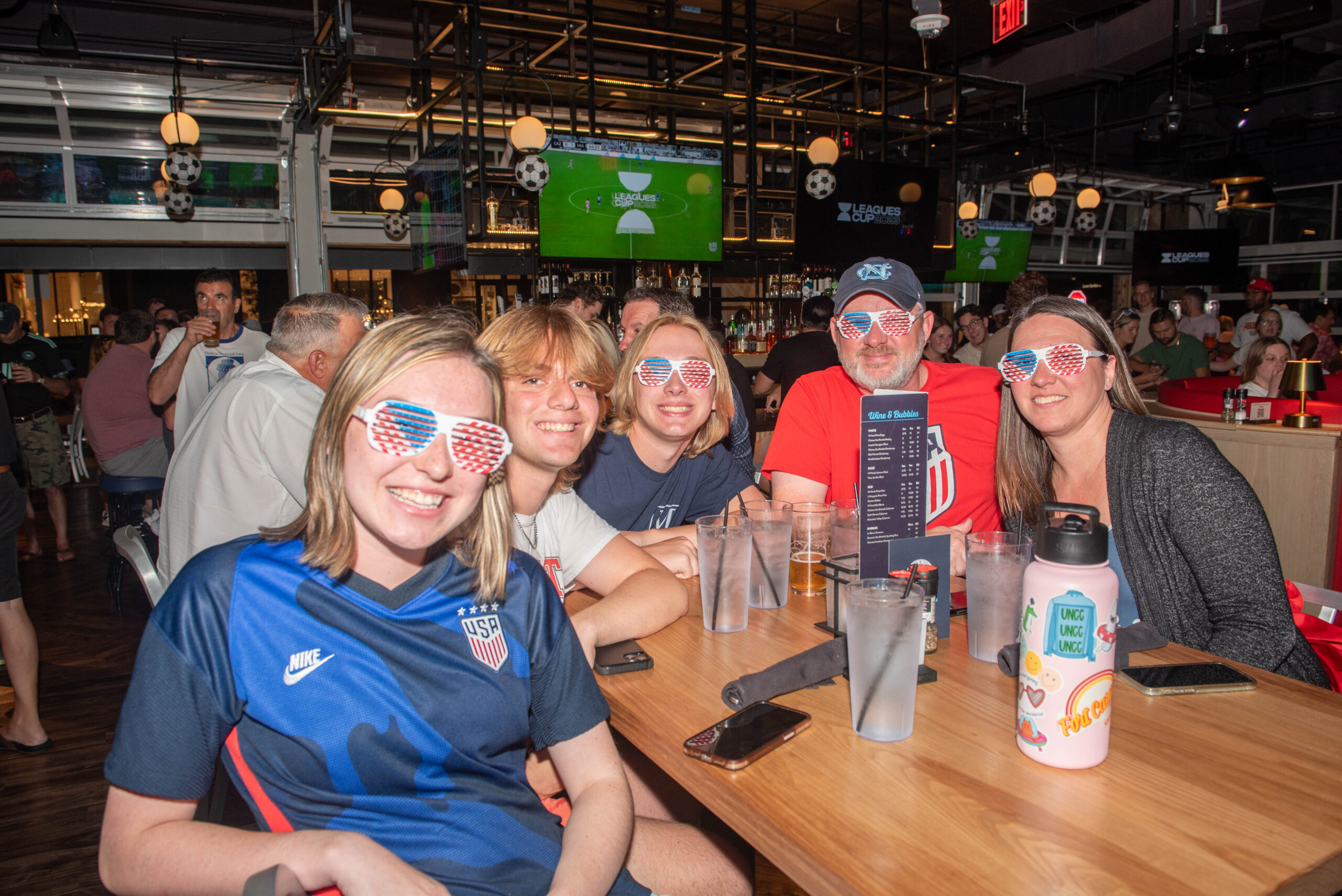group enjoying family friendly soccer watch party at Sports & Social