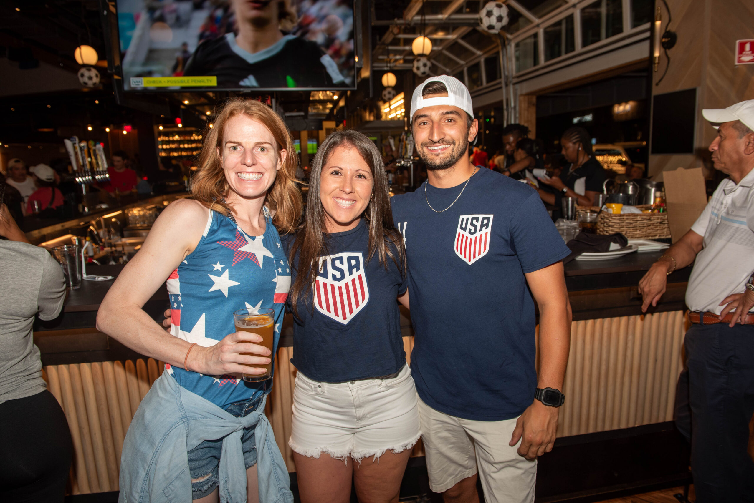 group enjoying family friendly soccer watch party at Sports & Social