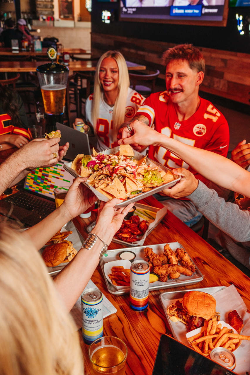 fantasy football friends passing out loaded nachos