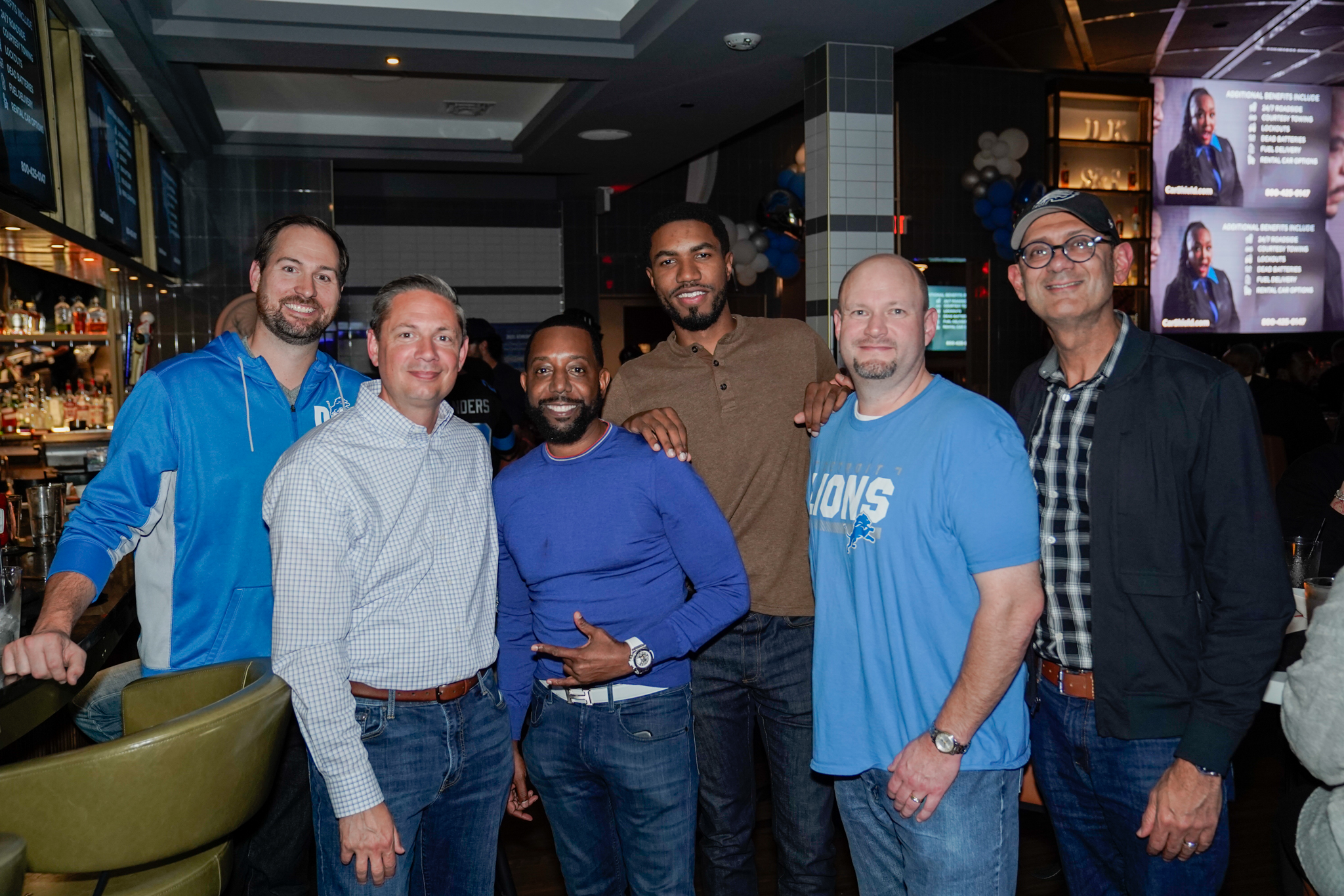 a group of men preparing for their fantasy football draft party