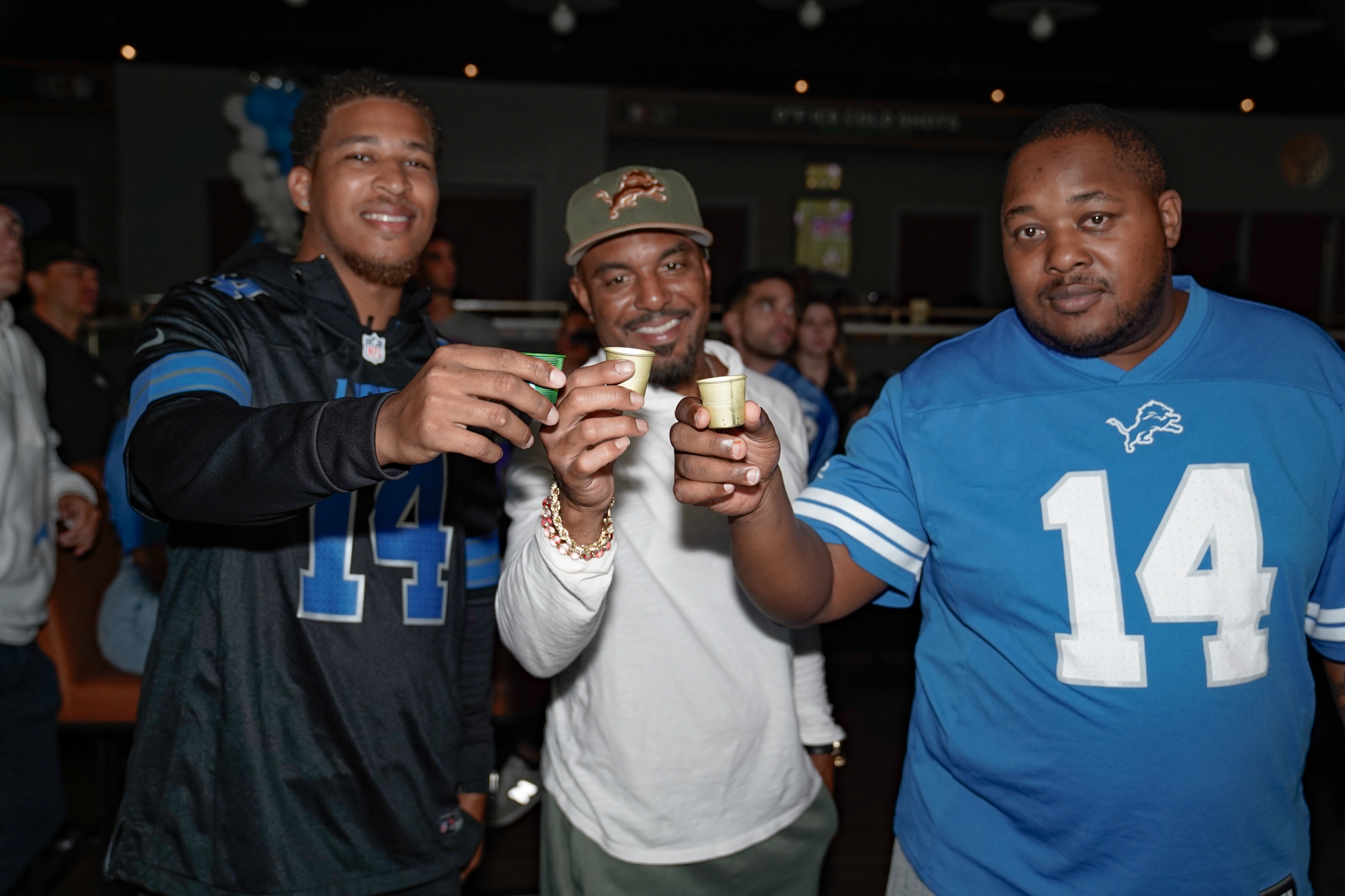 a group of men preparing for their fantasy football draft party